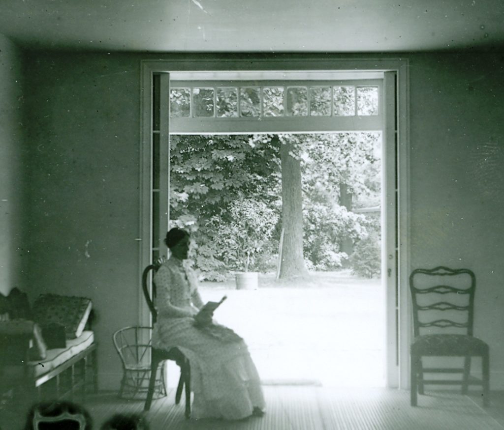 1905 photograph of Jane Reuben Haines sitting in conservatory